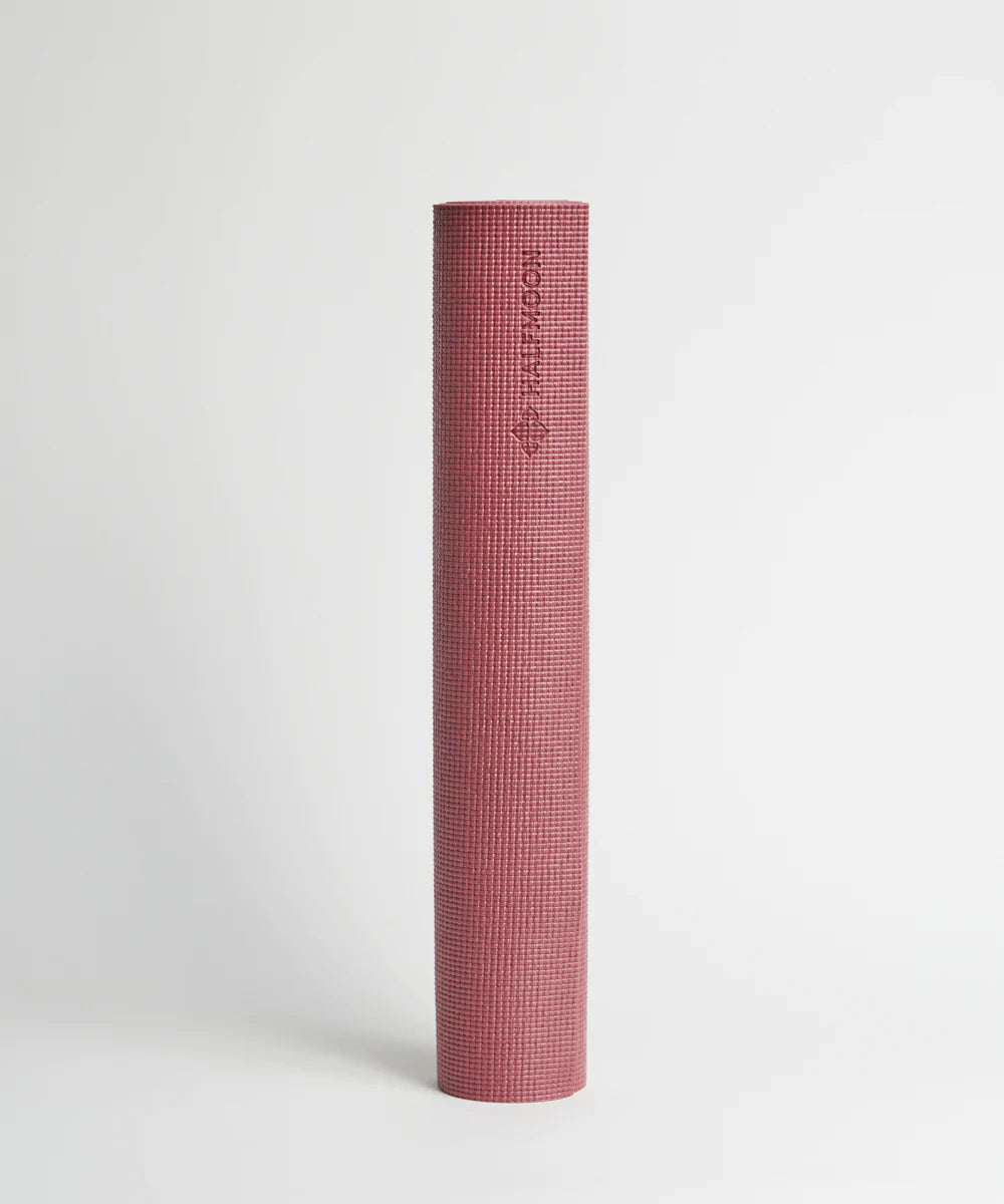 a pink toothbrush is sitting on a white surface 