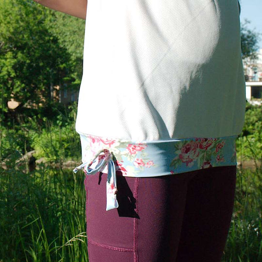 a woman in a pink dress holding a kite 